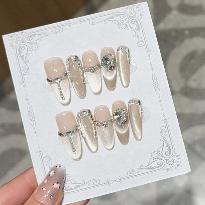Glamorous nail tips with rhinestone and glitter effects Stornfield