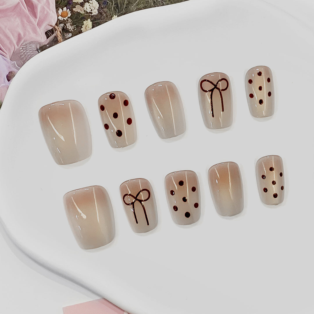 Artificial nail tips with bow and dot patterns Stornfield