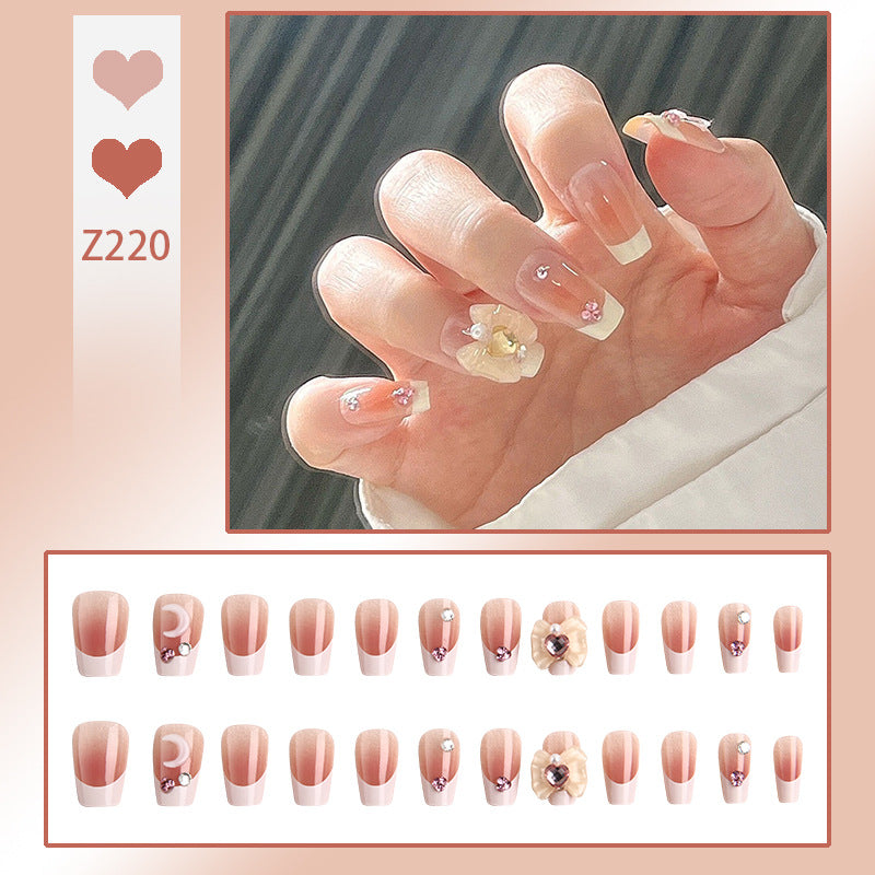 Artificial nail set with elegant floral decorations and glitter accents Stornfield