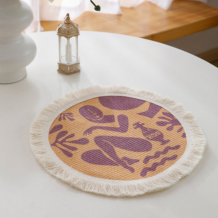 Round woven placemat with fringes and abstract figure motif Stornfield
