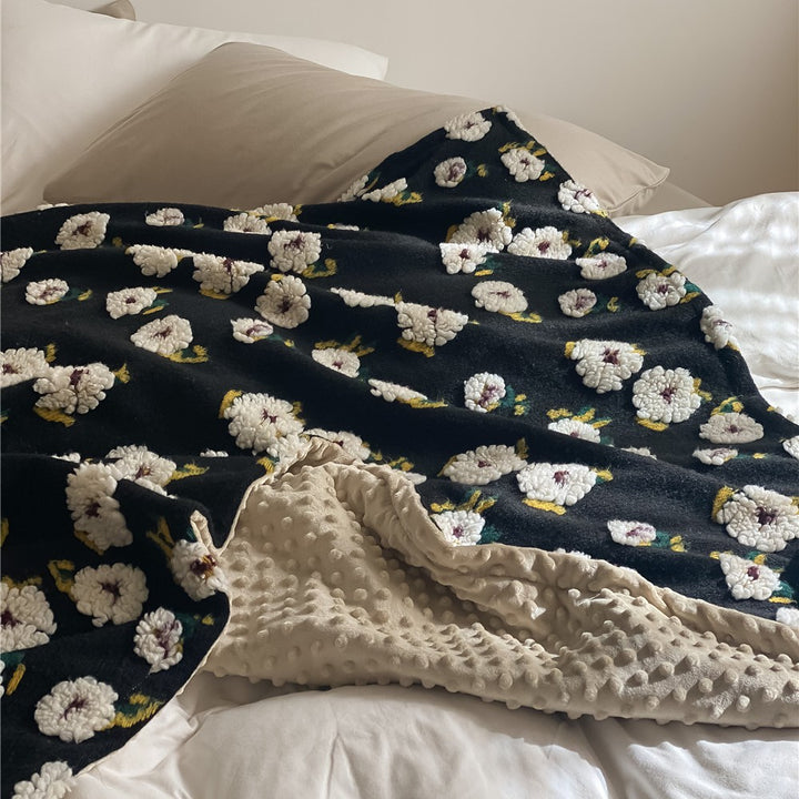 Cuddly blanket with floral bouclé surface and minky reversible fleece