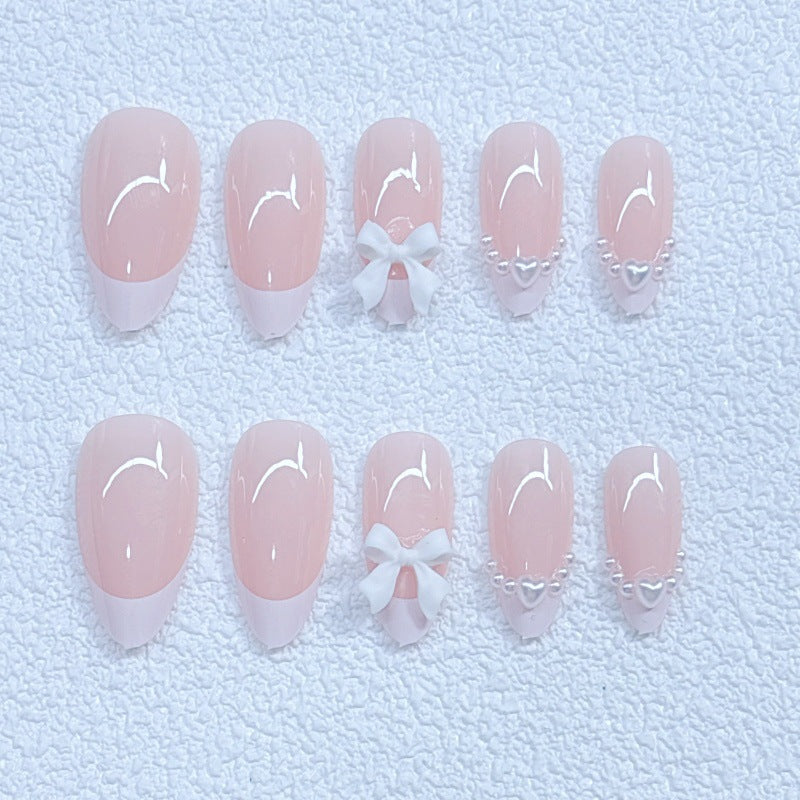 Elegant artificial nails with curved tips and decorative bows Stornfield