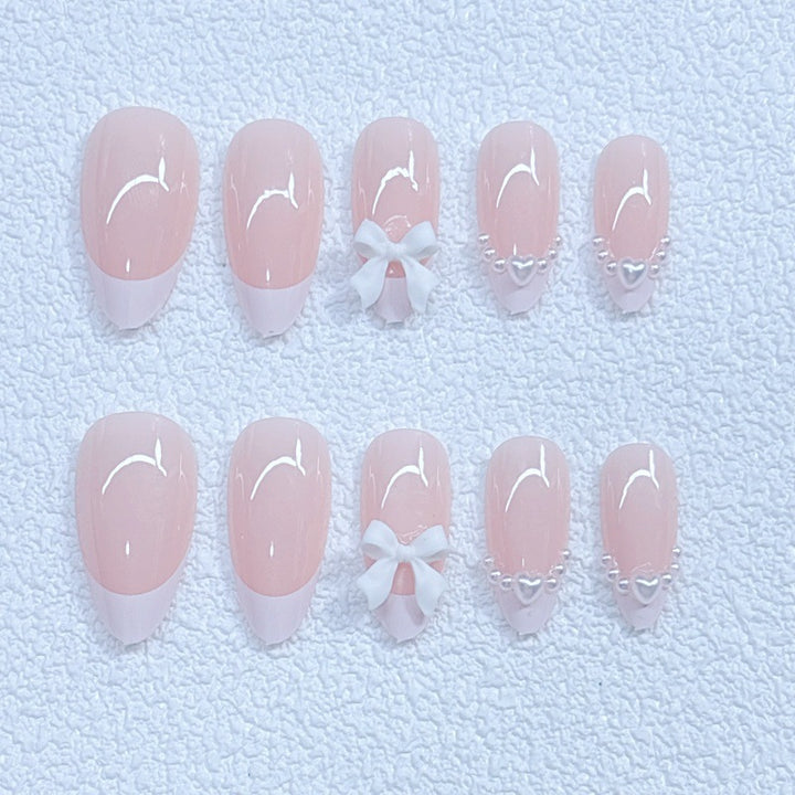 Elegant artificial nails with curved tips and decorative bows Stornfield