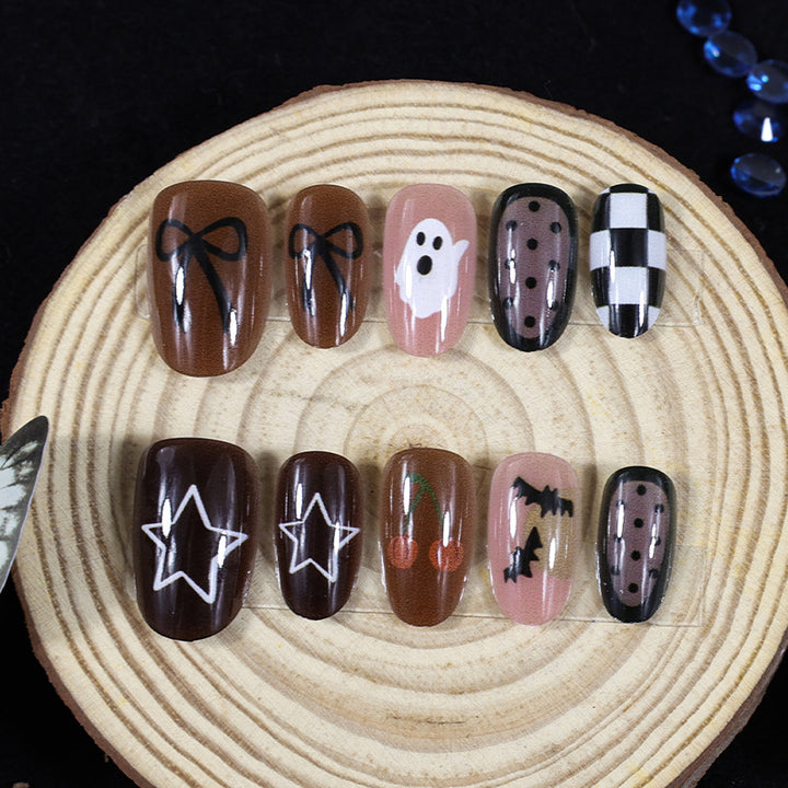 Artificial nail set with creative Halloween designs and glittering accents Stornfield