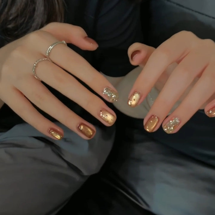 Elegant artificial nails with shimmering effects and sparkling accents Stornfield