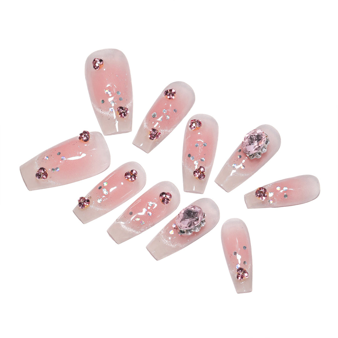 Artificial nail extensions with artistic glitter accents Stornfield