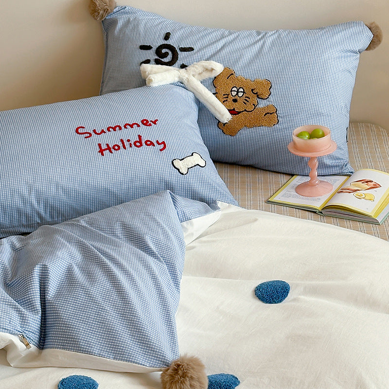 Children's bedding set with striped duvet cover, checkered decorative pillow, and plush application