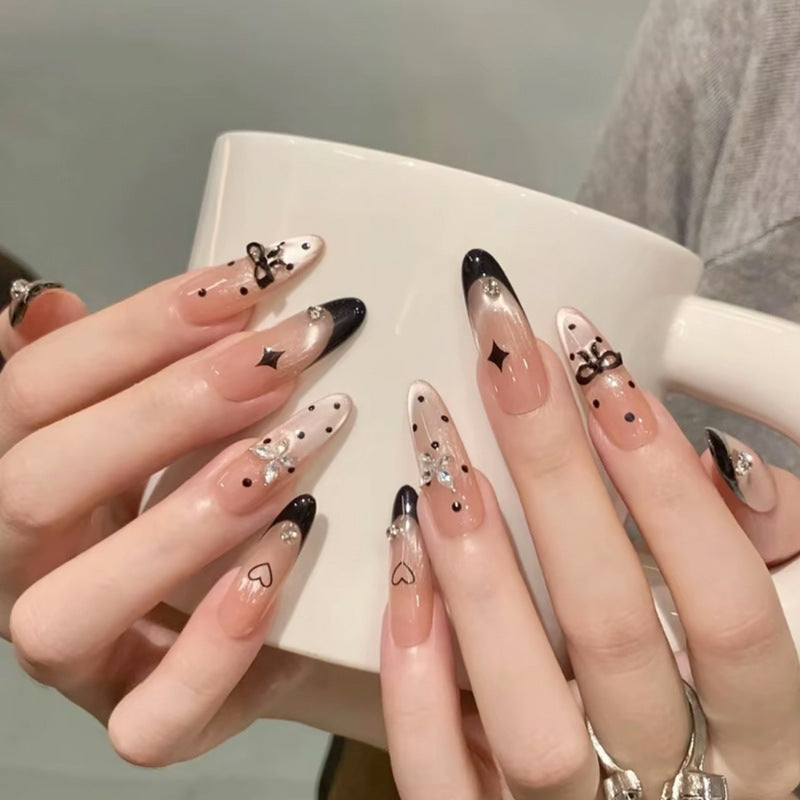 Nail art set with elegant black and white design and sparkling applications Stornfield