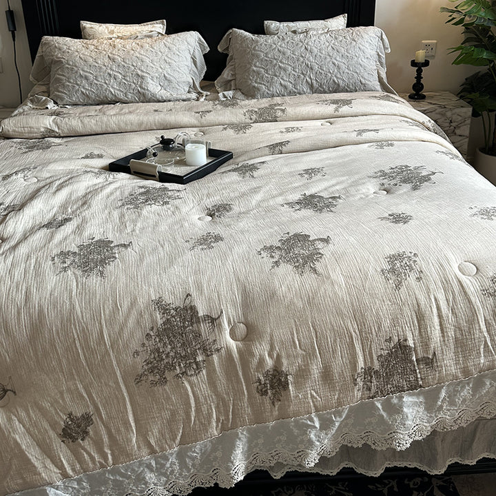 Quilted bedspread with lace trim and vintage stripe pattern