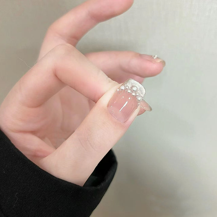 Elegant artificial nails with pearl decorations and glitter effects Stornfield