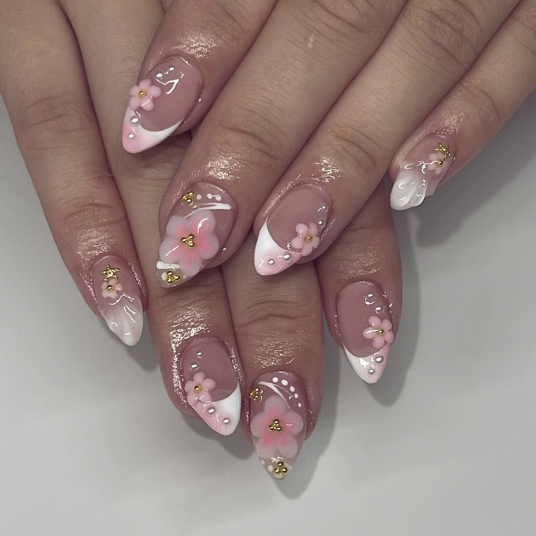 Artful nail extensions with floral patterns and glitter accents Stornfield