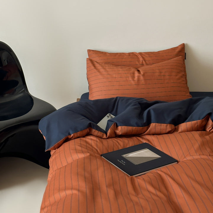Reversible cotton satin bedding set with fine striped pattern and contrasting backside