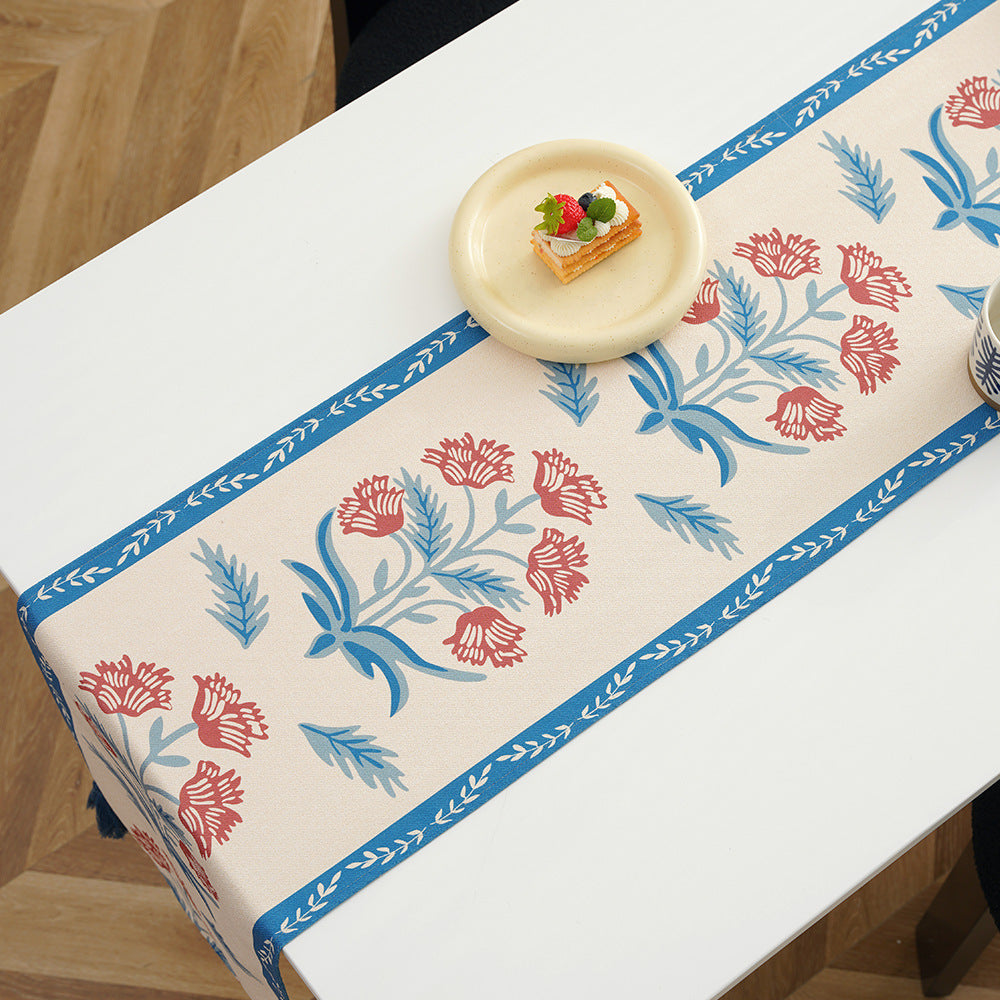 Table runner made of linen blend with floral block print motifs and tassels
