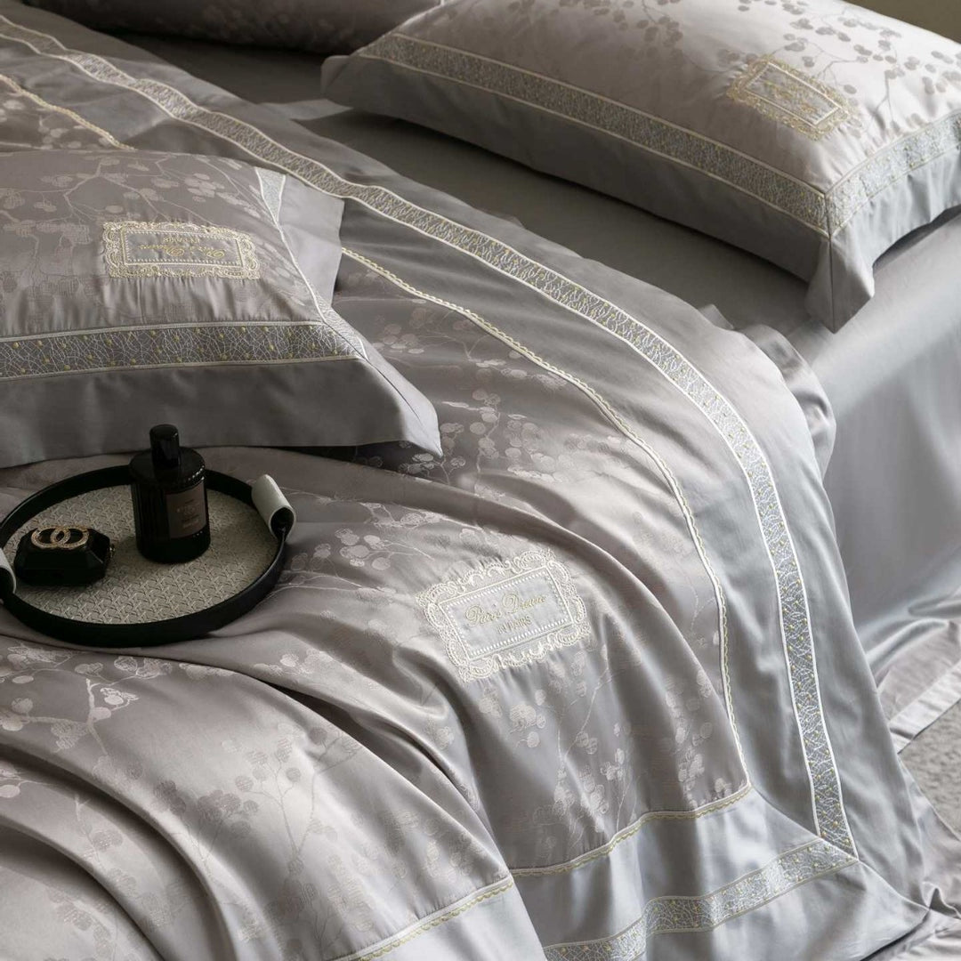 Luxurious satin bedding with jacquard floral pattern and lace trim