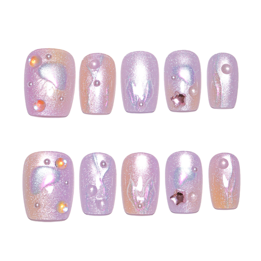 Artificial nail art with sparkling accents and transparent color gradient Stornfield