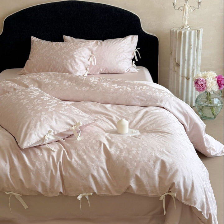 Luxurious cotton satin bed set with delicate ribbon ties and jacquard relief