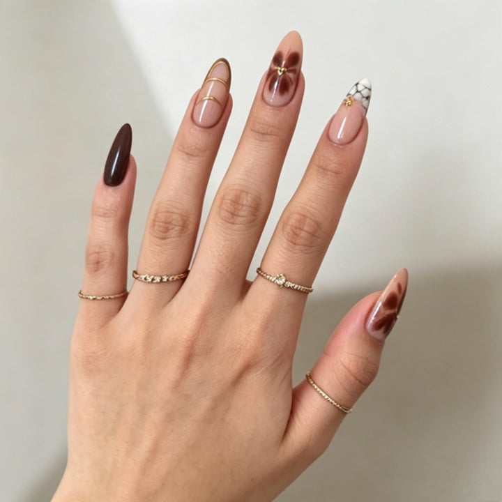 Artificial nails with elegant marble pattern and delicate accents Stornfield