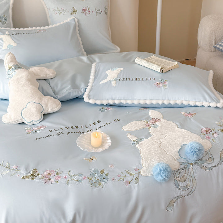 Playful cotton satin bedding set with appliquéd bunny pom-pom trim and floral embroidery