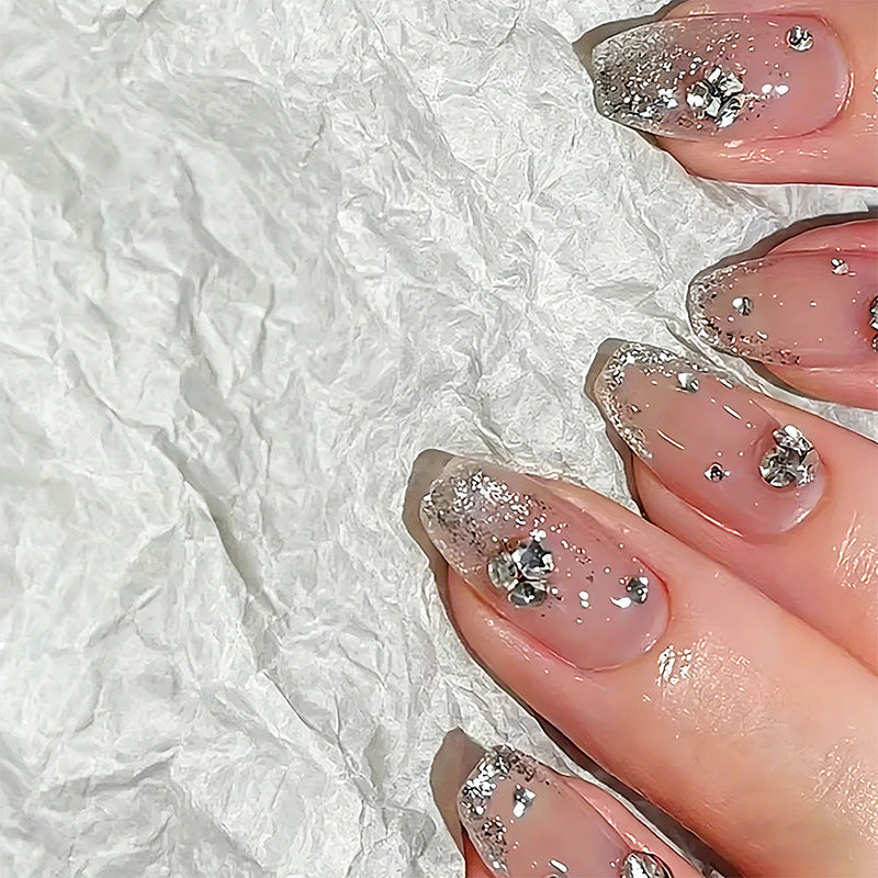 Glamorous artificial nails with glitter and rhinestone embellishments Stornfield