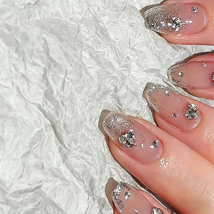 Glamorous artificial nails with glitter and rhinestone embellishments Stornfield
