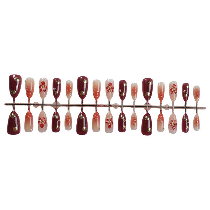 Acrylic nail set with elegant floral accents and glitter details Stornfield