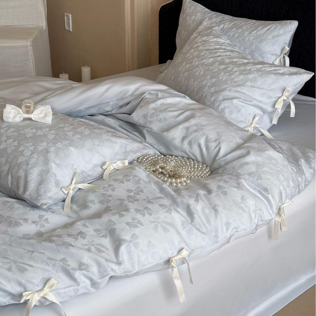 Luxurious cotton satin bed set with delicate ribbon ties and jacquard relief