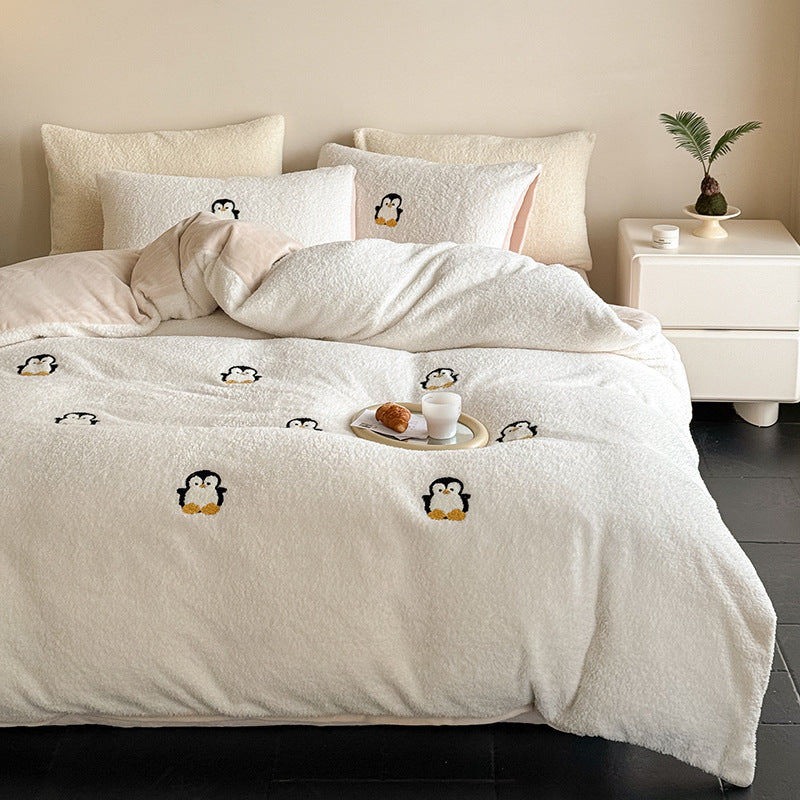 Cozy sherpa bedding set with embroidered penguin motifs and reversible function