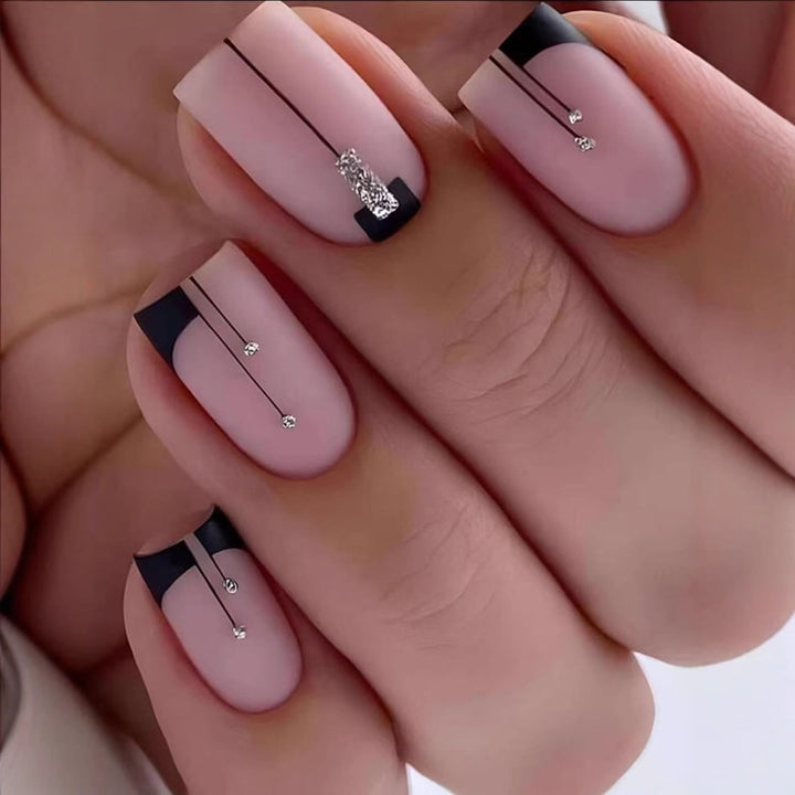 Acrylic nail set with elegant rhinestone accents and stylish lines Stornfield