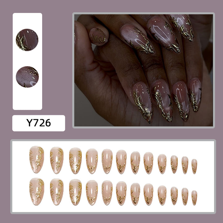 Exquisite artificial nails with golden decorations Stornfield