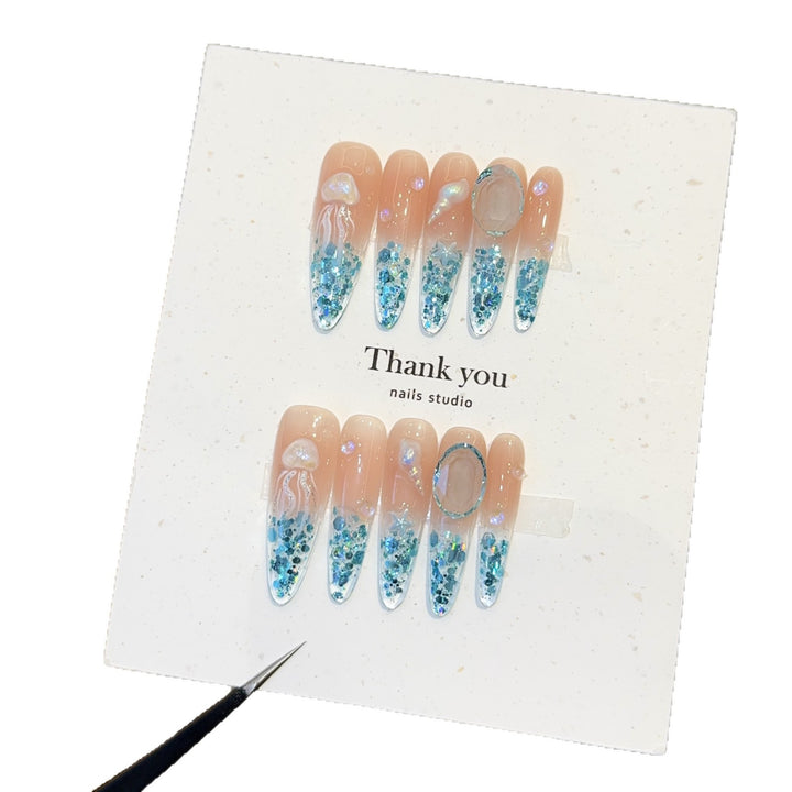 Creative artificial nails with maritime designs and sparkling accents Stornfield