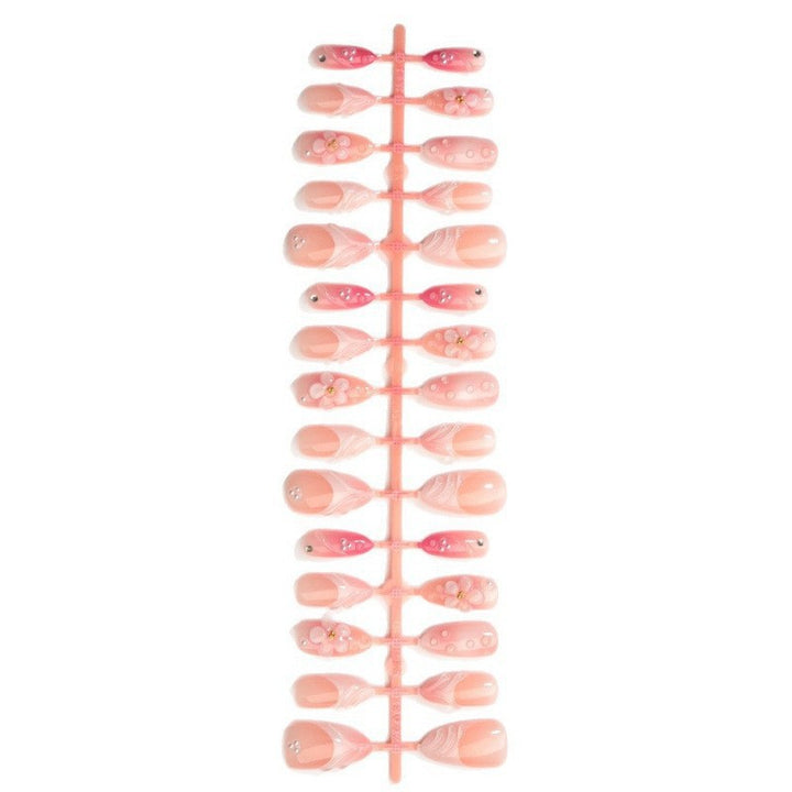 Artificial nail set with delicate floral and glitter accents Stornfield