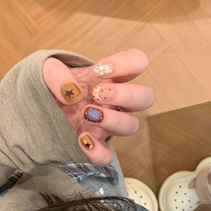 Artificial nails in modern design with star and gradient elements Stornfield