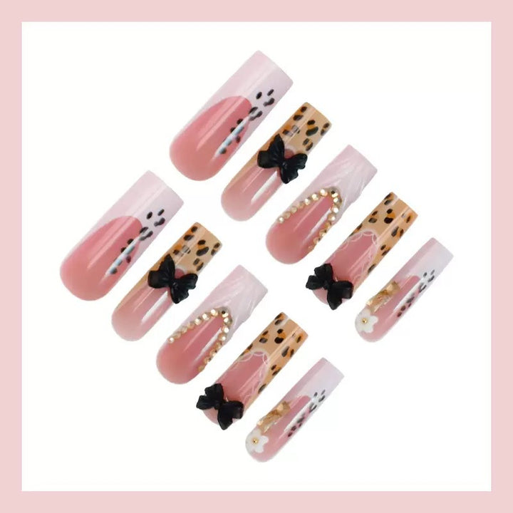 Artistic Press-On Nail Design with Bow and Animal Print Accents Stornfield