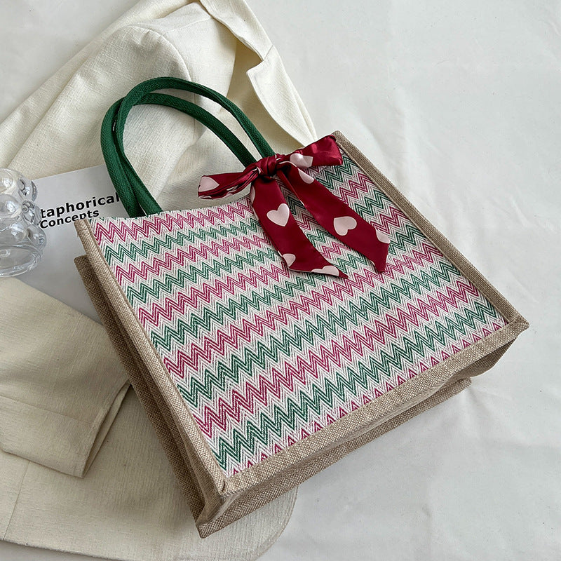 Textured Handbag with Decorative Bow