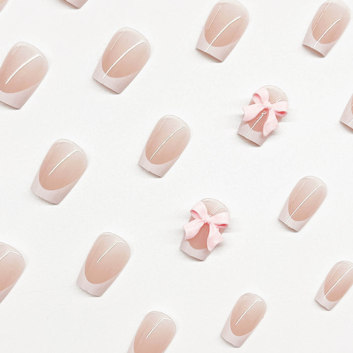 Decorative French Tip Nail Extensions with Bow Accents Stornfield