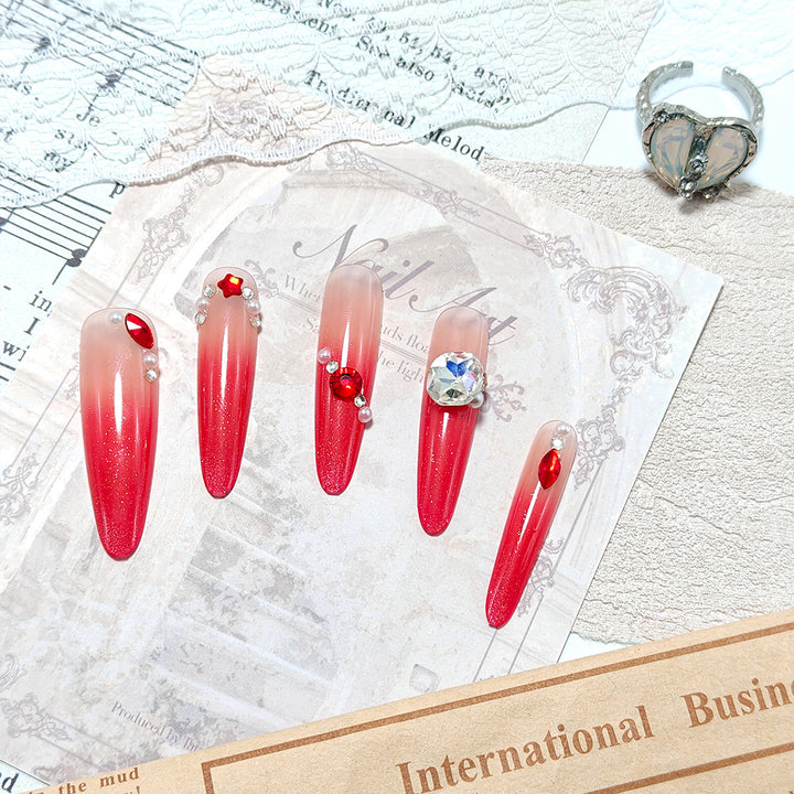 Artificial nails in elegant ombre style with glitter and jewelry accents Stornfield