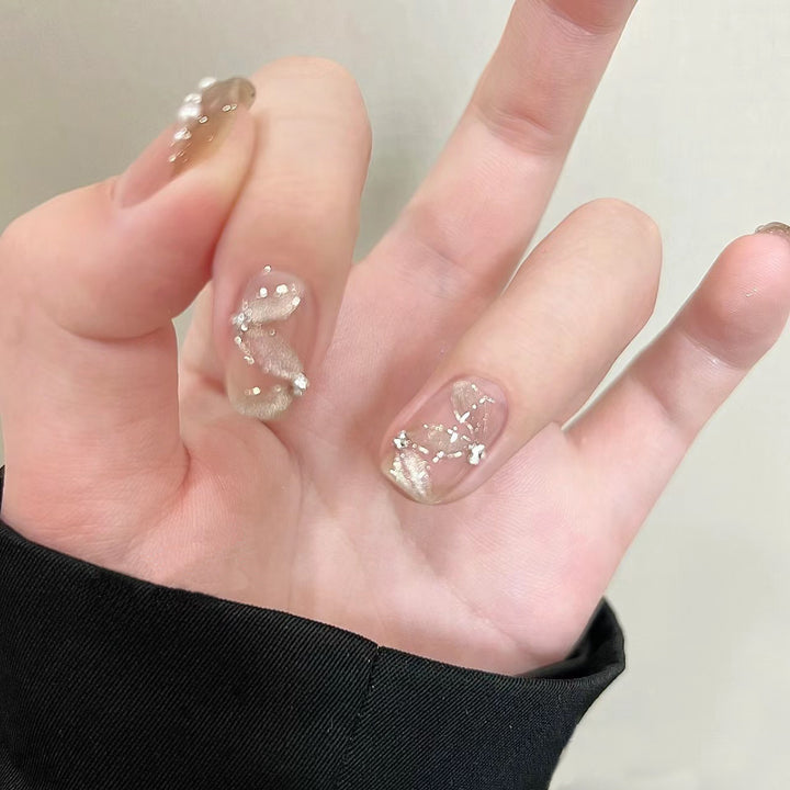 Elegant artificial nails with pearl decorations and glitter effects Stornfield