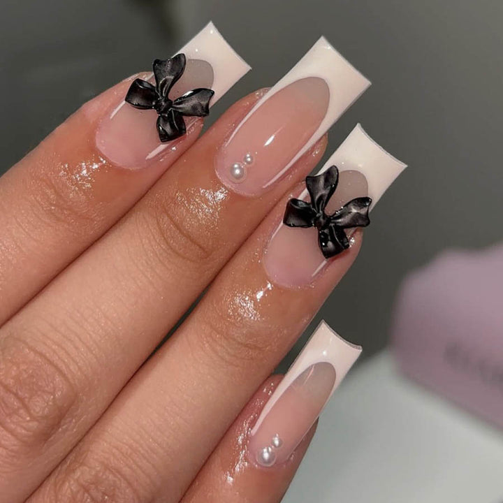 Acrylic nail set with stylish black and pearl details Stornfield