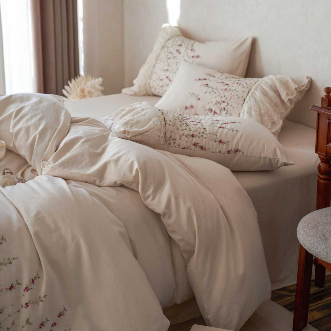 Vintage-inspired ruffled blanket and pillow set made of cotton muslin with delicate floral embroidery