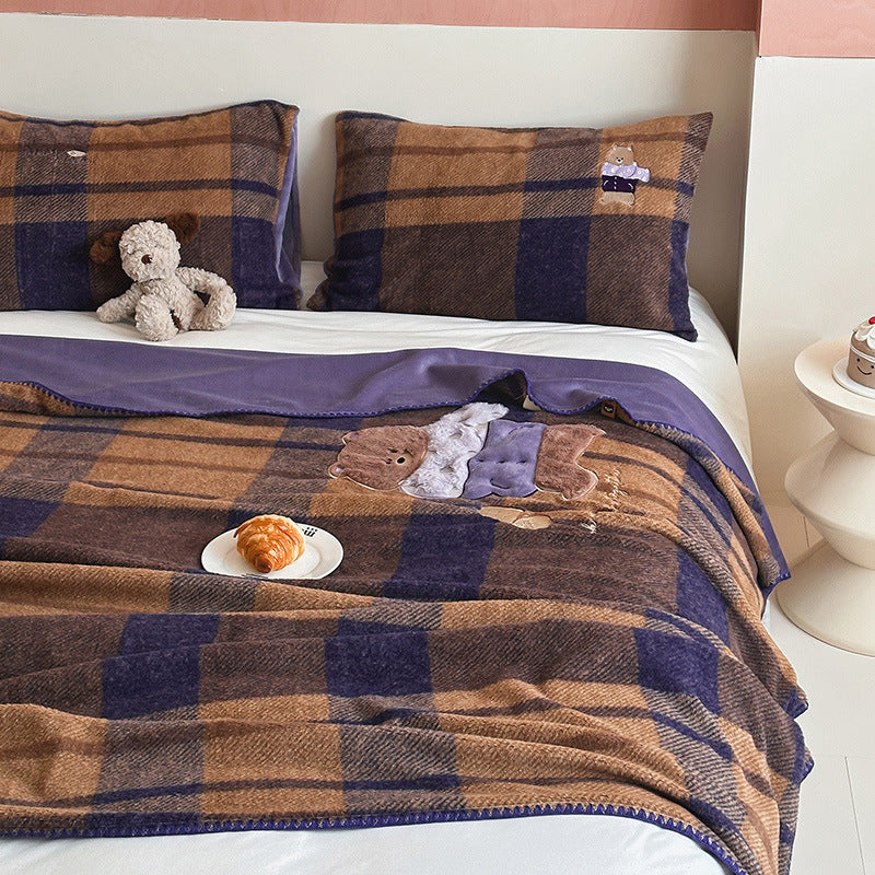 Plaid blanket checkered with appliqued animal motifs and soft velour lining