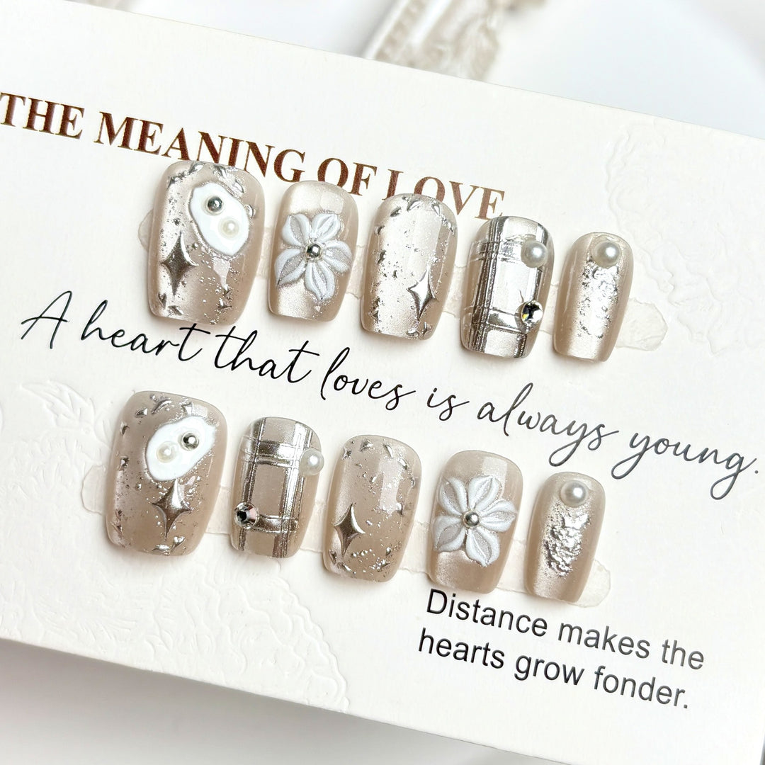 Artistic Press-On Nail Set with Floral and Metallic Accents