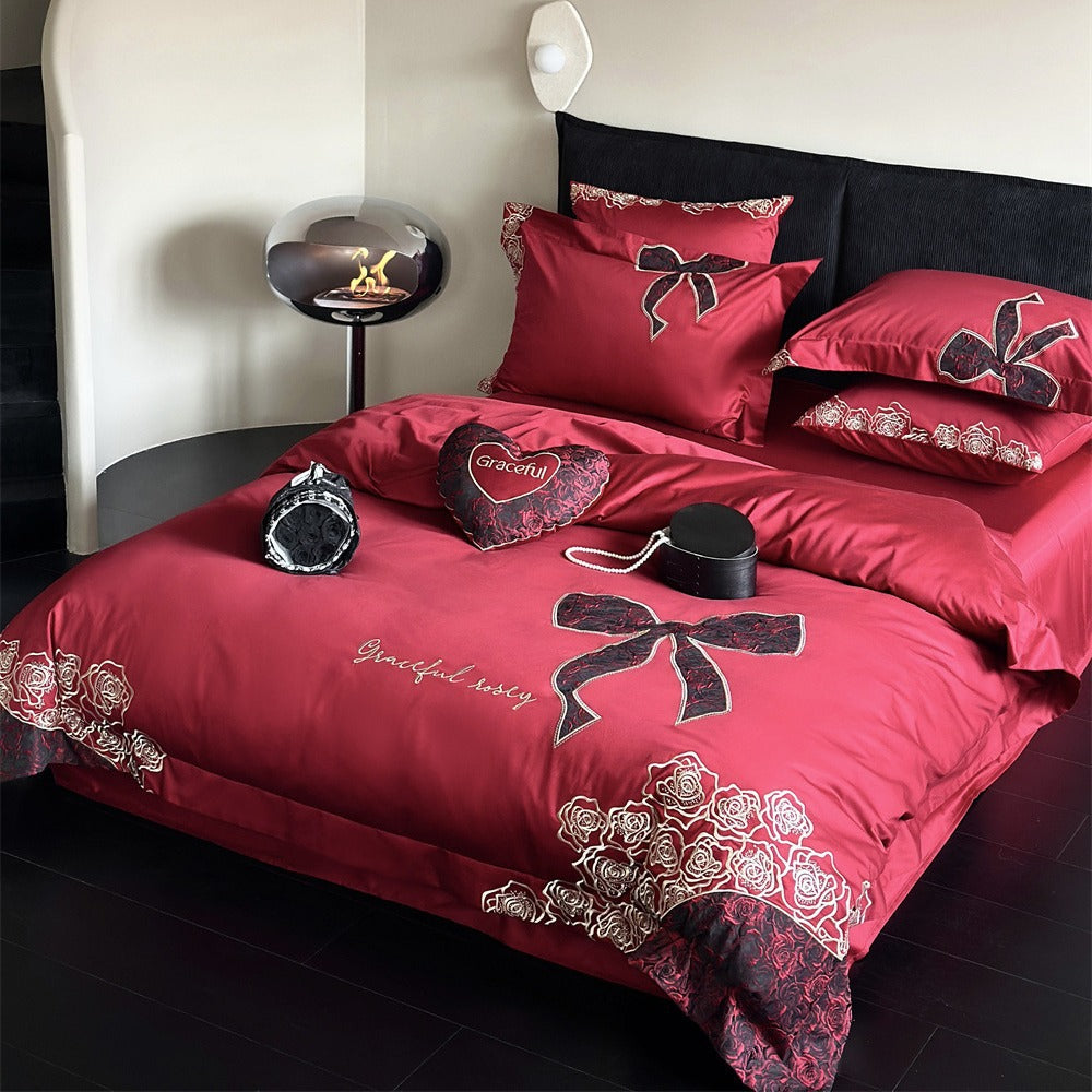 Luxurious satin bedding set with embroidered rose and bow motif