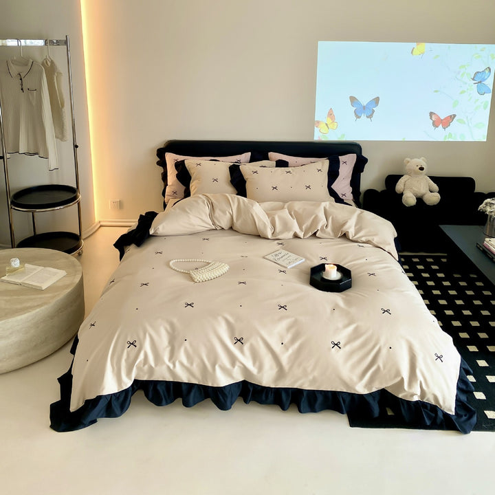 Reversible cotton satin bedding set with fine bow embroidery and ruffled edge