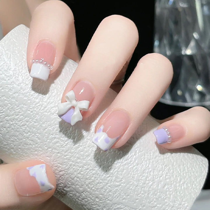 Nail art set with elegant wave patterns and delicate pearl accents Stornfield