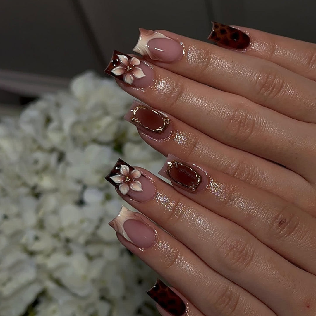 Artistic stiletto nails with elegant floral design and glitter effects Stornfield