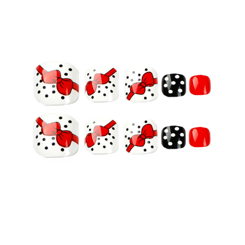 Artful toenail design with elegant bow motifs Stornfield