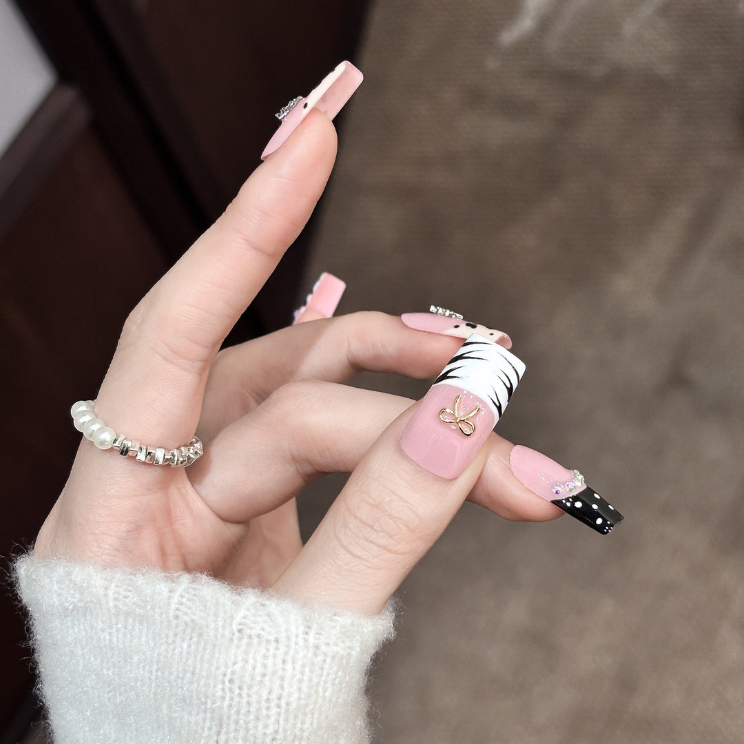 Artistic Press-On Nail Enhancements with Pattern and Gem Accents