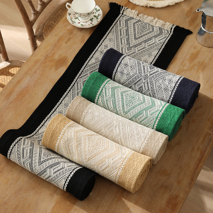 Woven table runner with geometric ethnic ornament and fringes Stornfield