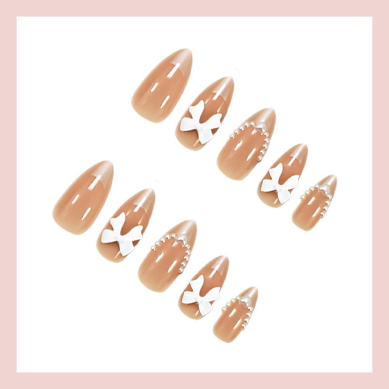 Artificial nail set with elegant bows and glitter details Stornfield