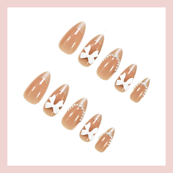 Artificial nail set with elegant bows and glitter details Stornfield
